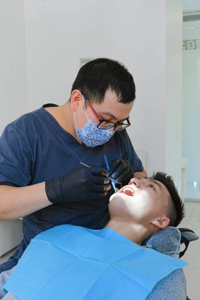 Dentist checking patient teeth with instruments